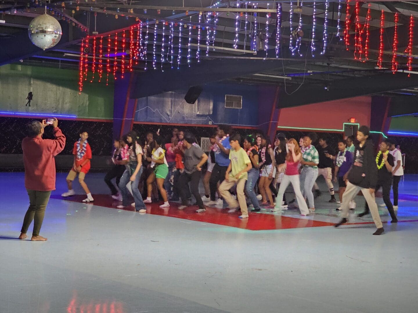 A group of people standing on the dance floor.