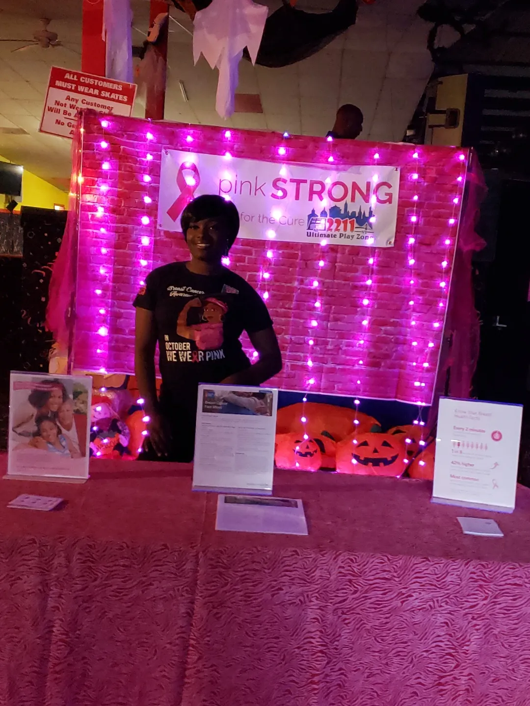 A person standing in front of a pink table.